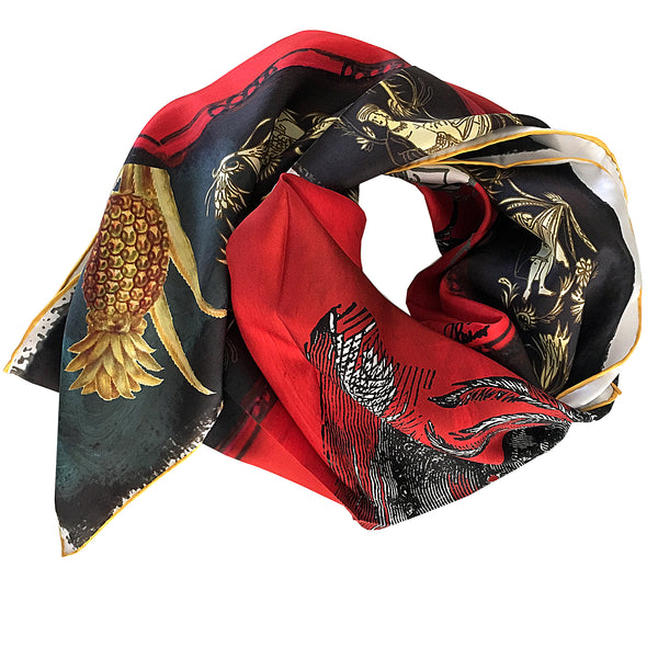 Showing the quality of the black, red and gold 100% silk scarf scrunched up 