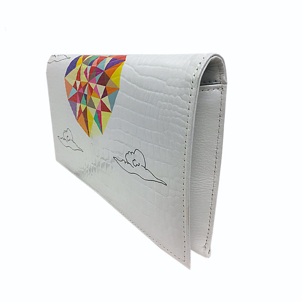White embossed glossy leather clutch purse. Printed with the symmetrical explosion of colors and the clouds design. With a snap fastener. Showing the neat stitching detail
