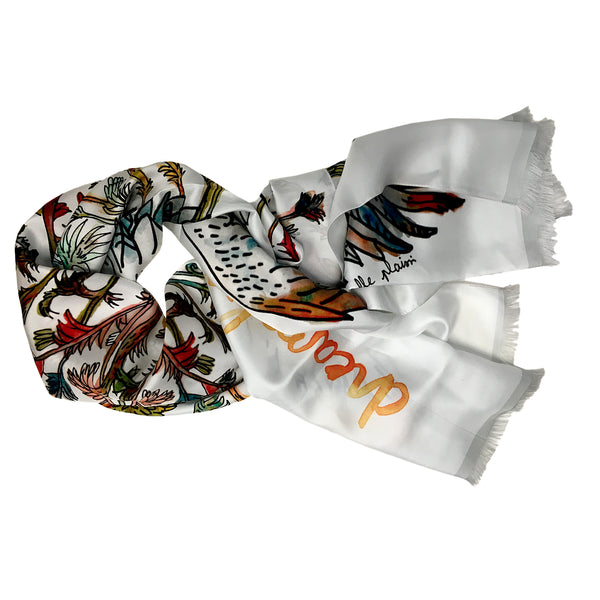 White printed 100% silk scarf with the leaves and branches in reds, orange, blues and grays. 