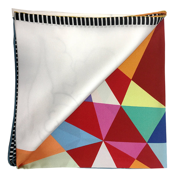 Folded to show the quality of this 100% silk scarf with hand rolled edges. explosion of symmetrical colors on a white background and black and white edges