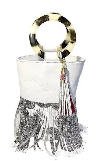 White leather bucket bag with printed black and white leather fringes. Black and white resin handles and leather key chain